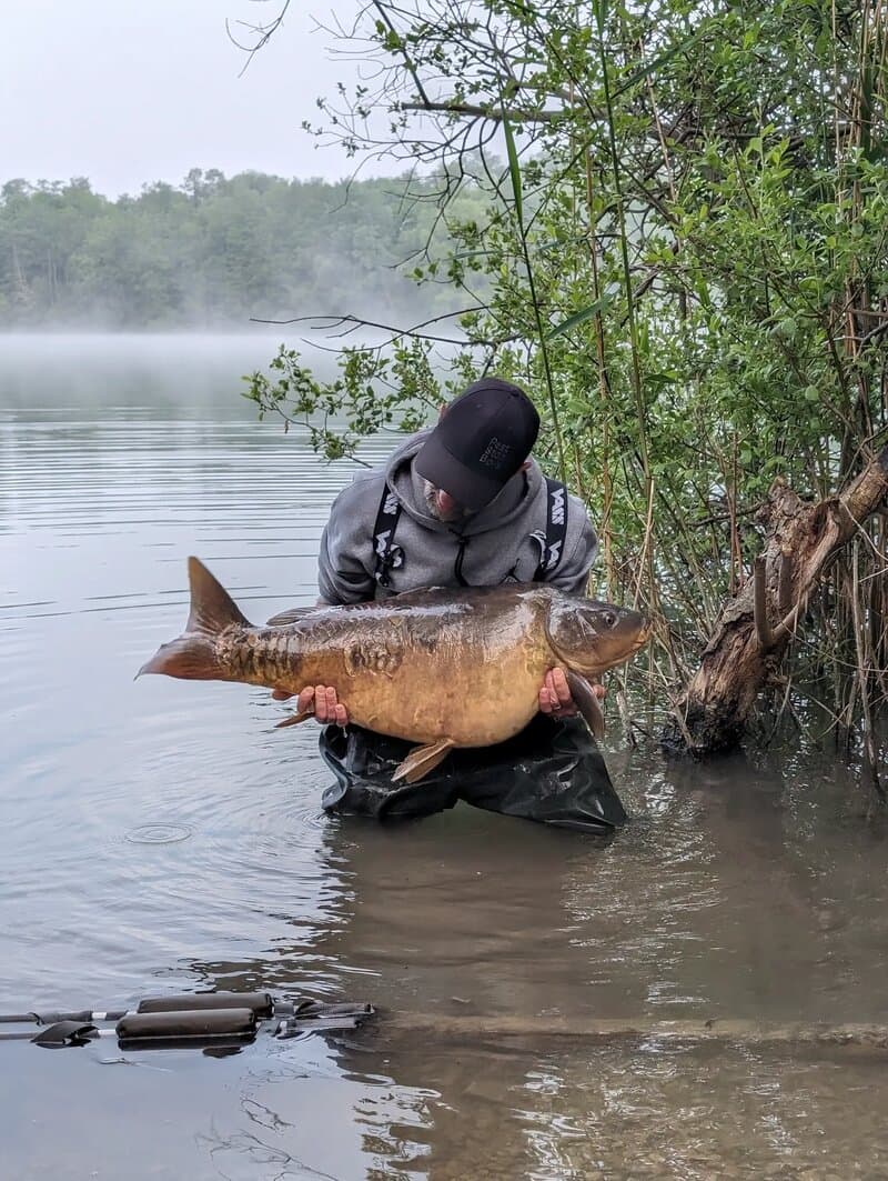 Angler holding a large carp